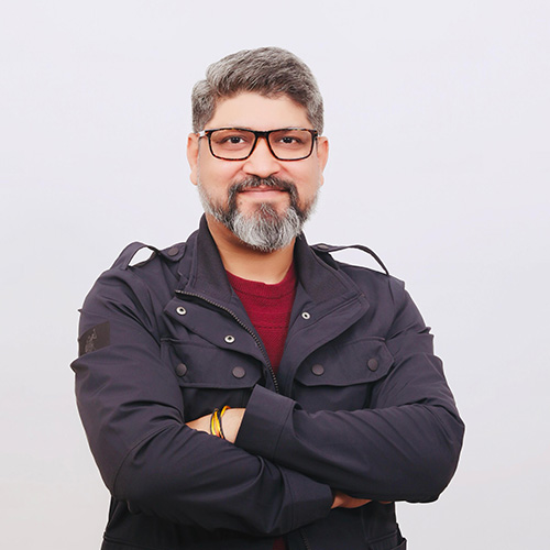 Portrait of Rajeev Kaushik, Sales Director at B&W International for India, with glasses and folded arms against a light background.